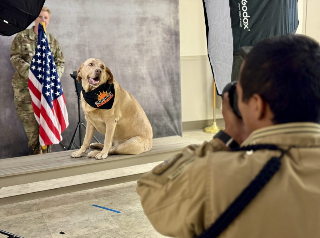 Ortega taking a picture of Sunburst Academy service dog