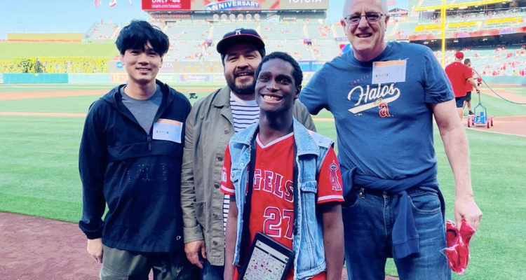 Greyson, a student at OCDE's Harbor Learning Center, with Duey Luu, a staff member from his group home, and OCDE Speech and Language Specialists Art Marmelejo and Paul DePerry.