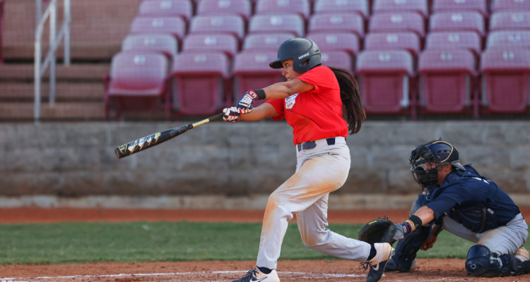 Jillian Albayati attempts a hit while at bat during a softball game.