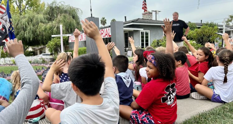 Orangethorpe 9:11 students raise hands