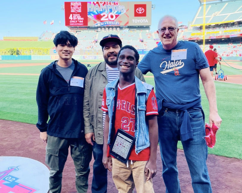 Greyson, a student at OCDE's Harbor Learning Center, with Duey Luu, a staff member from his group home, and OCDE Speech and Language Specialists Art Marmelejo and Paul DePerry.