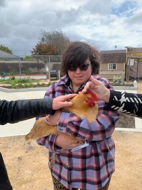 OCDE Adult Transition Program student Stacy with a 4-H club chicken named Goldie
