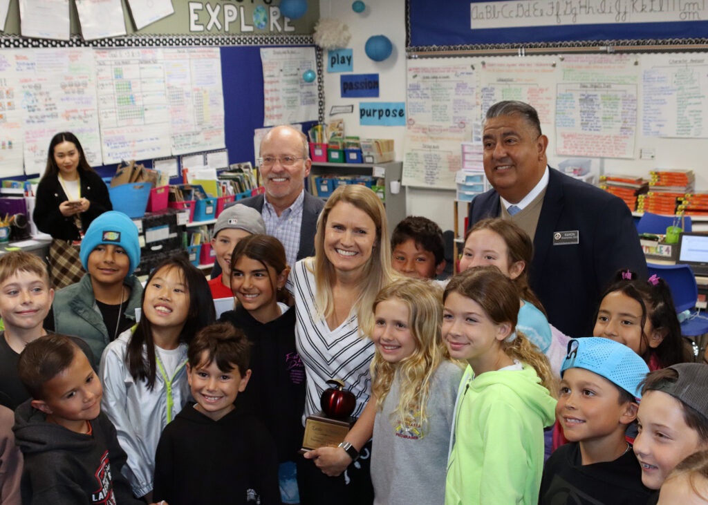 Esencia K-8 School teacher Leslie Whitaker poses for photos with her students, colleagues and Dr. Ramon Miramontes.