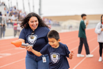 Warren Elementary School student Isaiah Ramirez competes in the torch relay event with support from Instructional Aide Yaritza Mercado at the 52nd Special Games at Bolsa Grande High School on May 19. (Photos courtesy of Garden Grove Unified School District)