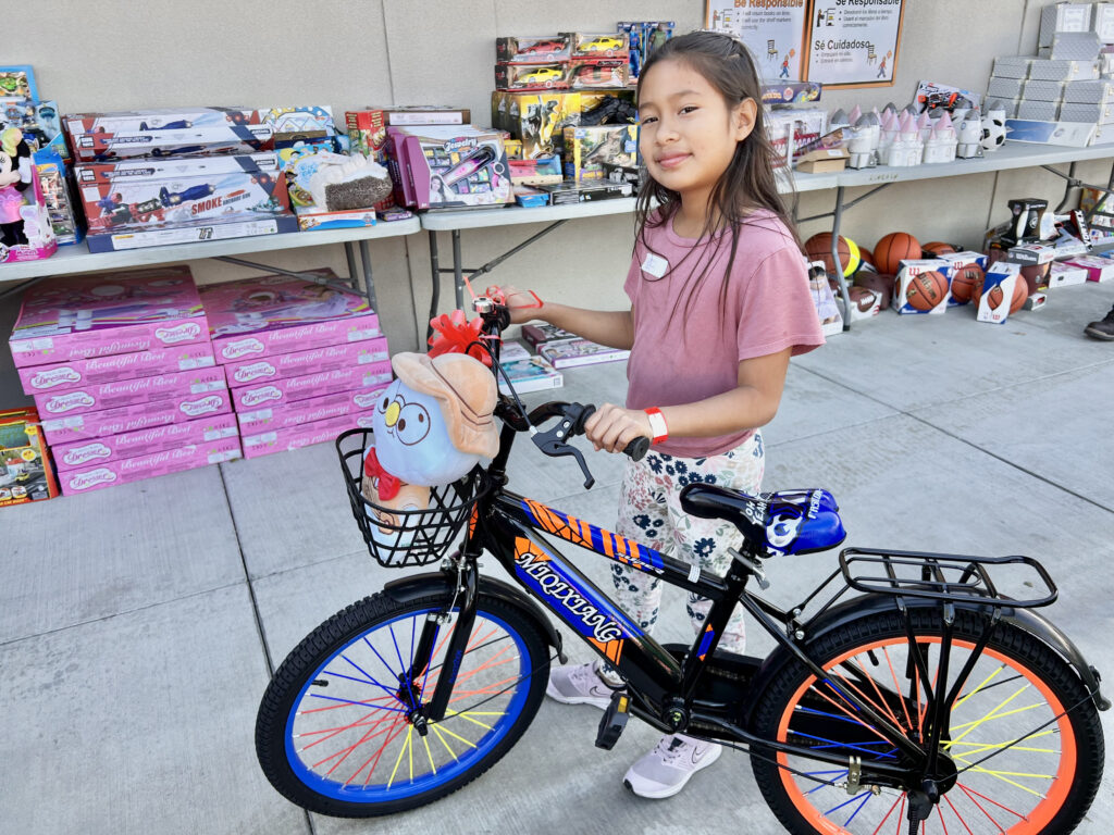 Fourth-grade student Dayana Lopez from Orange Grove Elementary in the Anaheim Elementary School District received a brand new bike and toys at a distribution event on Dec. 9.