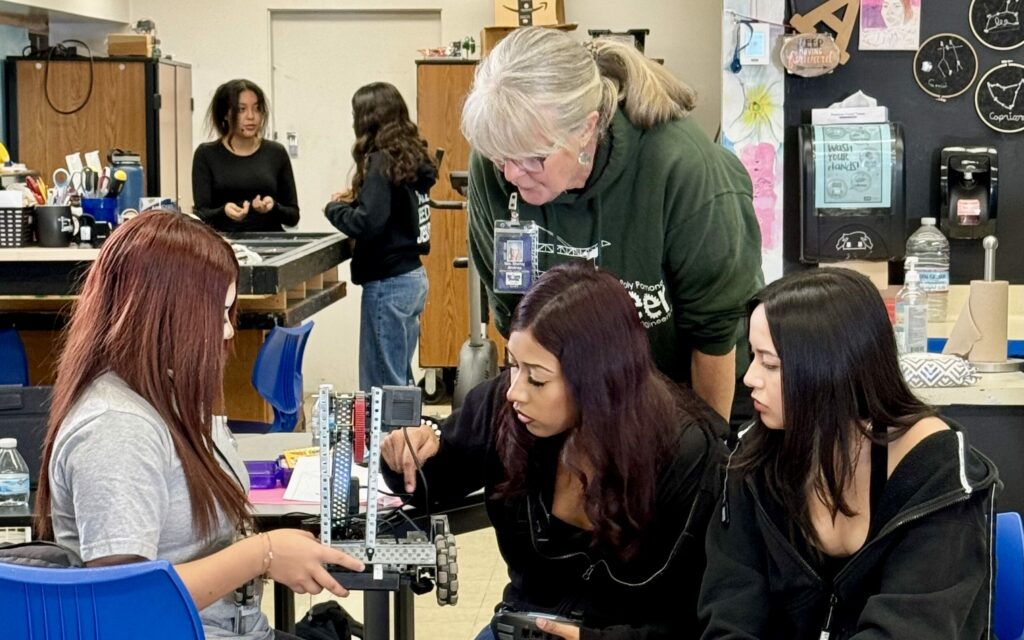 Career technical educator Shelley Andros helps students from Buena Park Middle School's Femineer program through the design and building process of their robot.