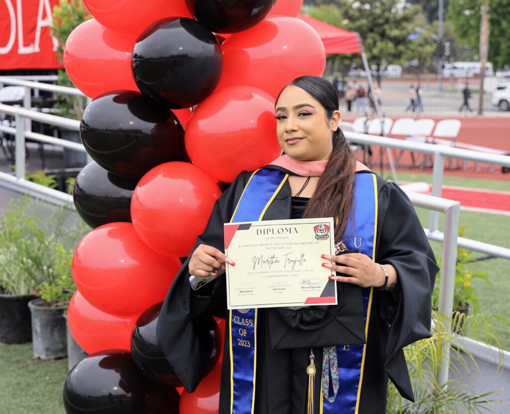 Former student Martha Trujillo earns her honorary certificate of promotion from eighth grade on May 31. (Fullerton School District)