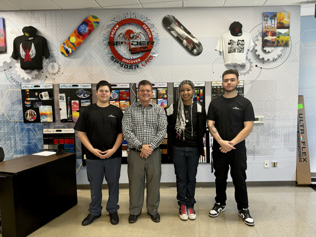 CTE teacher Michael Poirier poses with Spyder Lab student mentors Davian, Light and Alex at OCDE’s Harbor Learning Center South Campus in Fountain Valley.