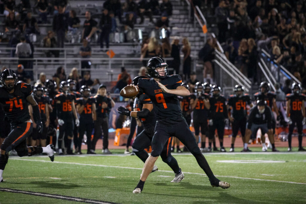 Brady Edmunds drops back to pass the football.