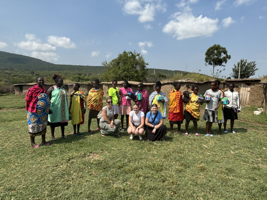 Fullerton Union High School teacher Alexandra Walker and her family with Maasai Mara school-aged children in Kenya, where they donated 400 menstrual pads to support education and address period poverty. (Courtesy of Alexandra Walker)