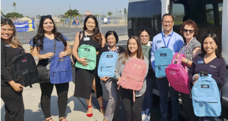 OCDE McKinney-Vento District Liaisons and SchoolsFirst FCU members distribute backpacks filled with school supplies to campuses on July 24.