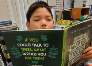 Student Daniel Lee reads books for the STEAM Race to Space Reading Challenge.