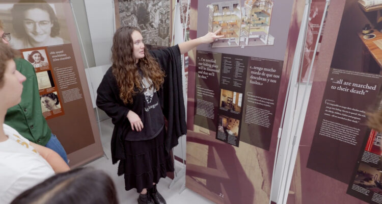 Los Alamitos High School student Maleah Fennessy guides students through the Anne Frank - A History for Today exhibit at Los Alamitos High School on Oct. 16.