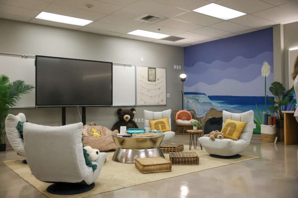 Ocean View High School's WellSpace, "The Well Nest," features a mural of the ocean and soft chairs for students to decompress.