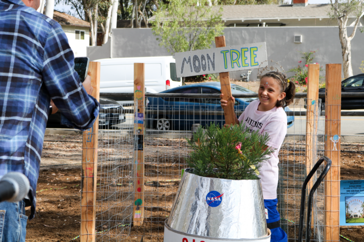 Santiago STEAM Magnet Elementary School student Emily Aguesse welcomes the NASA Moon Tree to campus on Oct. 14. (Saddleback Valley Unified School District)