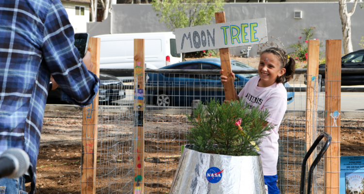 Santiago STEAM Magnet Elementary School student Emily Aguesse welcomes the NASA Moon Tree to campus on Oct. 14. (Saddleback Valley Unified School District)