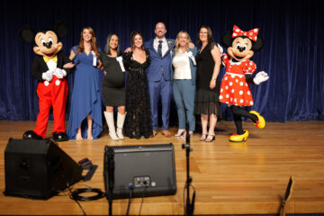 The six Orange County Teacher of the Year finalists are congratulated by Mickey and Minnie at the Disneyland Hotel.