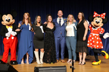 The six Orange County Teacher of the Year finalists are congratulated by Mickey and Minnie at the Disneyland Hotel.