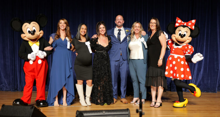 The six Orange County Teacher of the Year finalists are congratulated by Mickey and Minnie at the Disneyland Hotel.