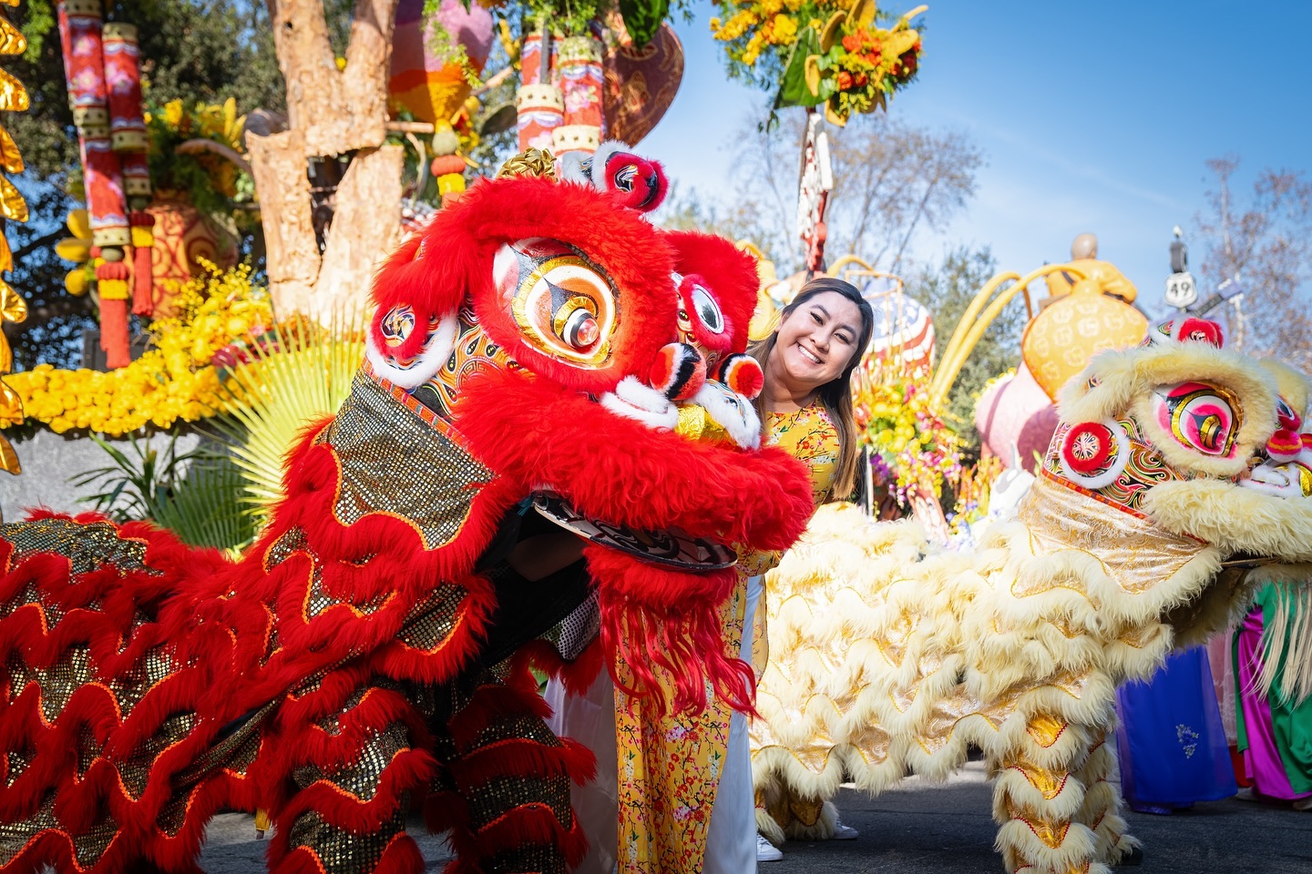 Mai-Khanh Cong-Huyen, Westminster High School’s Vietnamese language teacher, poses with student lion dancers before their performance at the 2025 Rose Parade on Jan. 1.