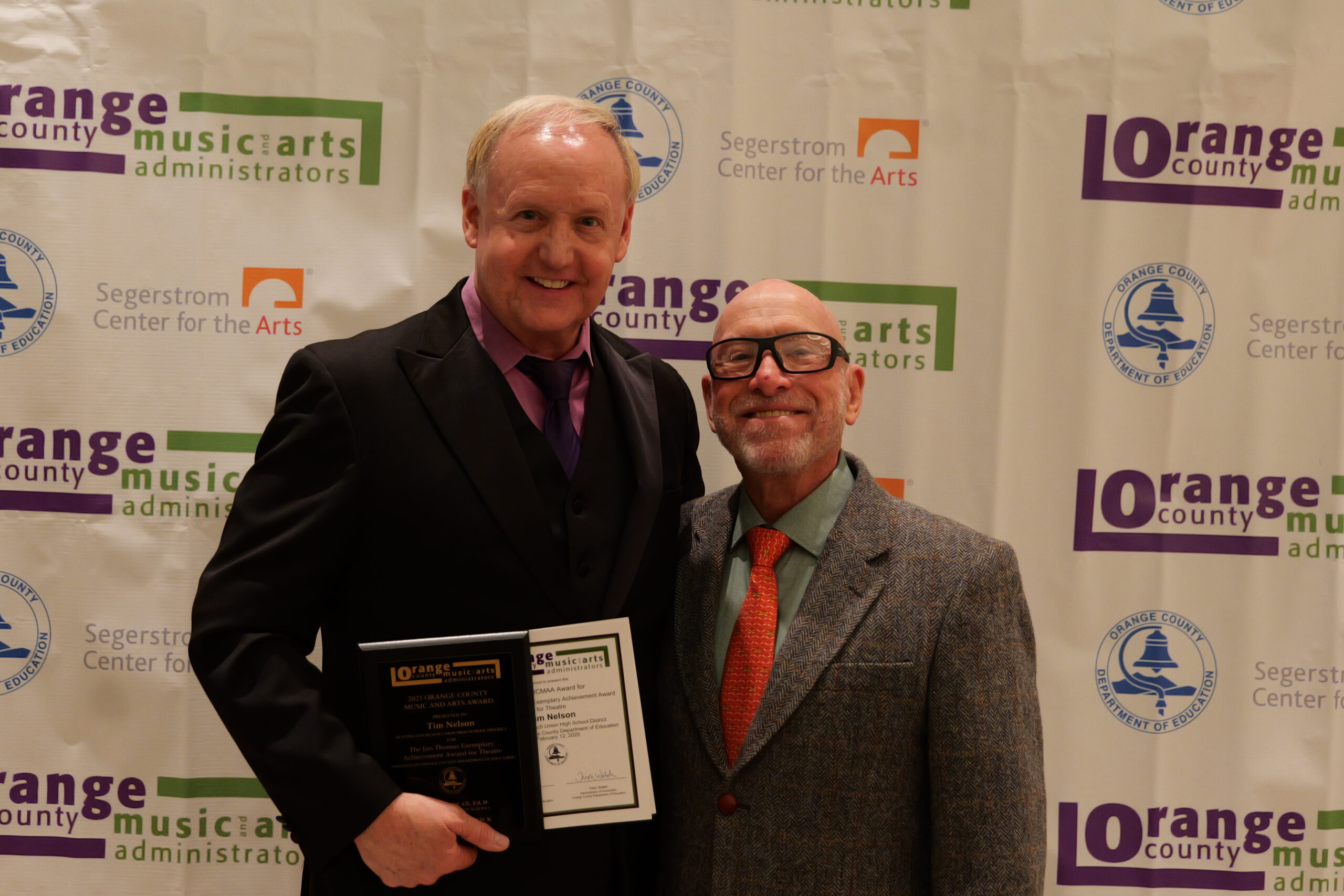 Tim Nelson of the Huntington Beach Union High School District, recipient of the Jim Thomas Exemplary Achievement Award for Theatre, poses with Jim Thomas, OCDE’s former coordinator of visual and performing arts, for whom the award is named.