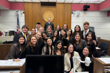 The El Dorado High School mock trial team celebrates their victory alongside Justice Thomas Delaney, the presiding judge. (Photo courtesy of the Placentia-Yorba Linda Unified School District)