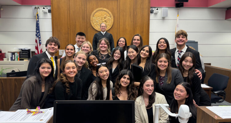 The El Dorado High School mock trial team celebrates their victory alongside Justice Thomas Delaney, the presiding judge. (Photo courtesy of the Placentia-Yorba Linda Unified School District)