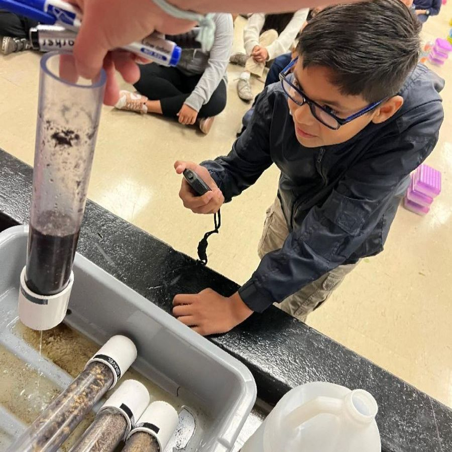 An elementary student participates in an Inside the Outdoors interactive lesson on water resources.