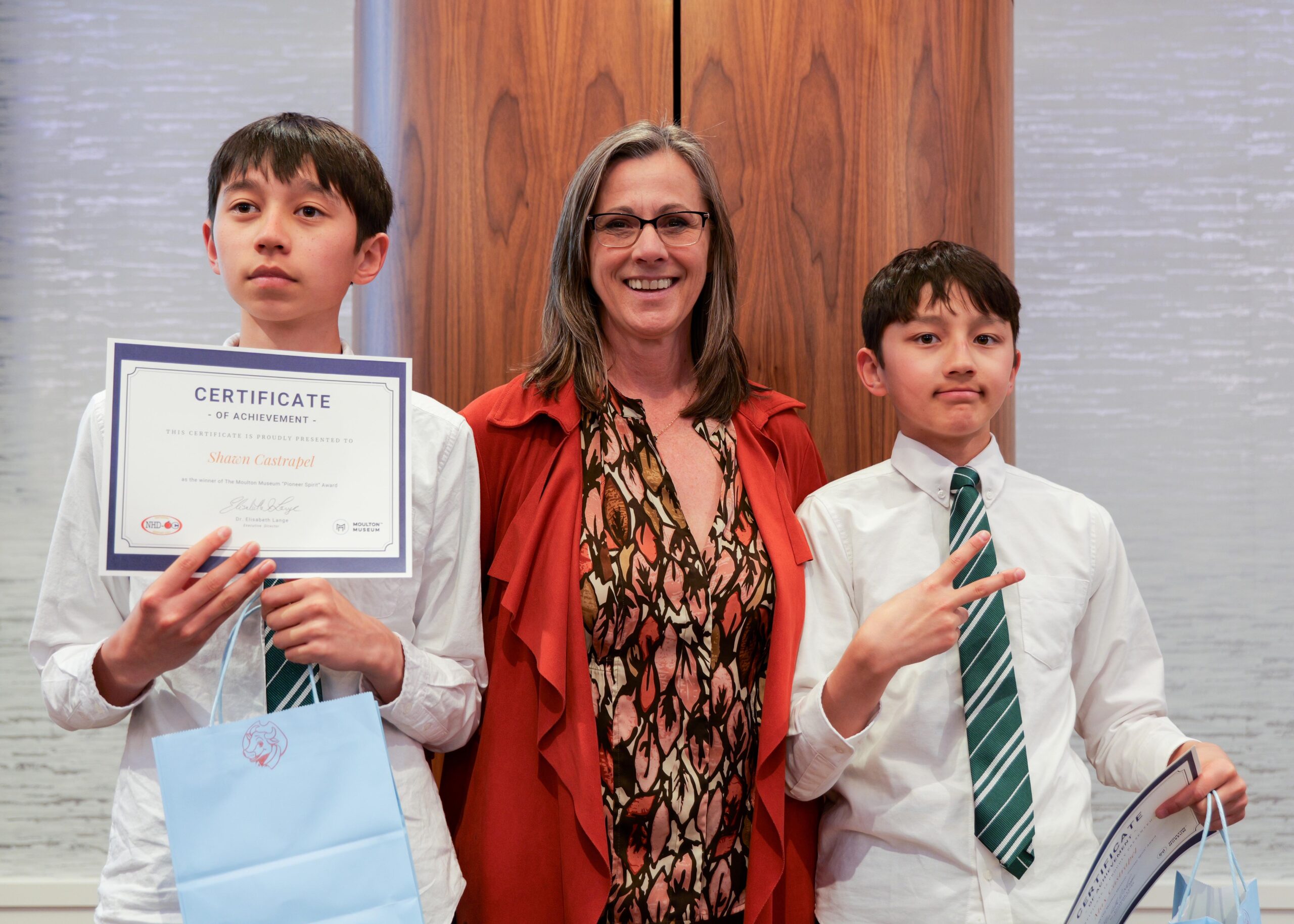 Shawn Castrapel and Max Castrapel of Sierra Vista Middle School in the Irvine Unified School District stand with Moulton Museum Executive Director Dr. Elisabeth Ida Lange during the NHD-OC awards ceremony on March 12.