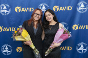 Two AVID Senior Standouts pose with bouquets ahead of the 2025 OC AVID Senior Standout Recognition and Scholarship Presentation, held April 23 at the Irvine Barclay Theatre.