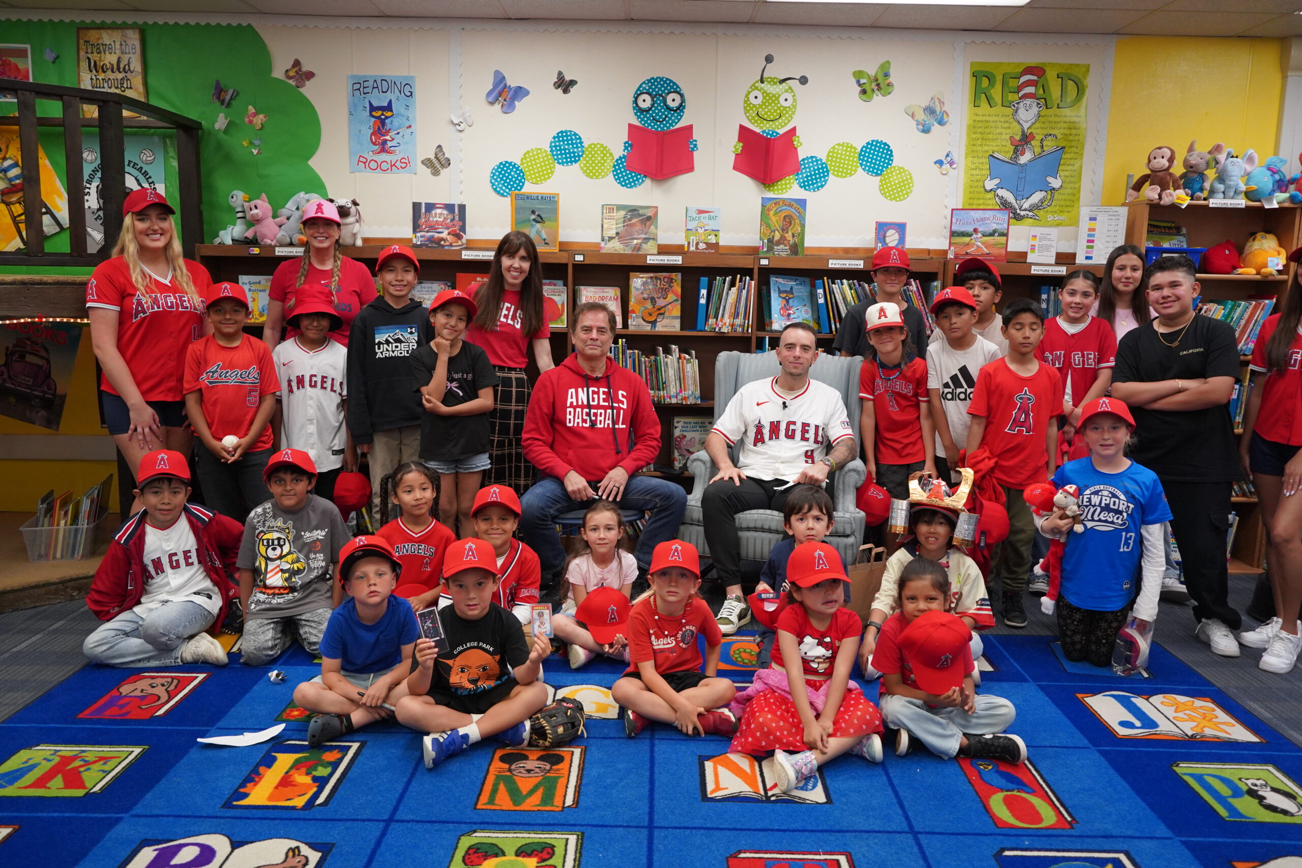 Los Angeles Angels shortstop Zach Neto and sports radio host Roger Lodge visit College Park Elementary students in Costa Mesa May 9.  (Angels Baseball Foundation) 