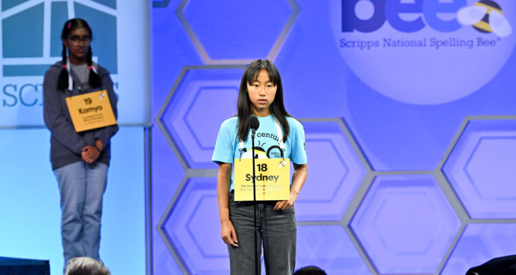 Speller Sydney Tran, of Irvine, California, representing The Orange County Register/O.C. Department of Education, competes in a preliminary round for the 2025 Scripps National Spelling Bee on May 27, 2025 in National Harbor, MD. ph: Craig Hudson / Scripps National Spelling Bee