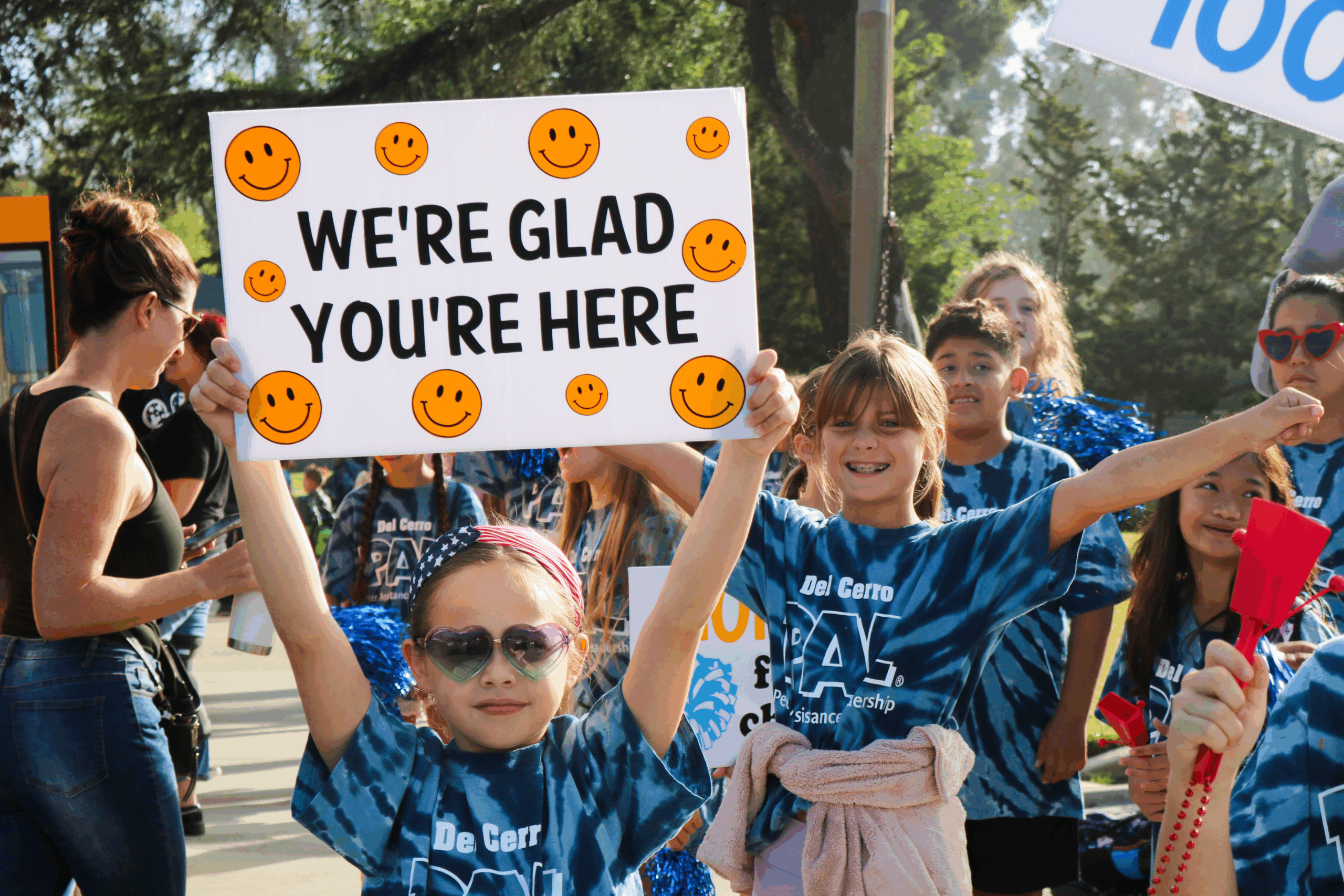 SVUSD student holding sign that says "We're glad you're here"