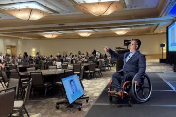 Dr. Stefan Bean speaks from the stage to an audience of mental health professionals at the School-Based Mental Health Summit in Costa Mesa.