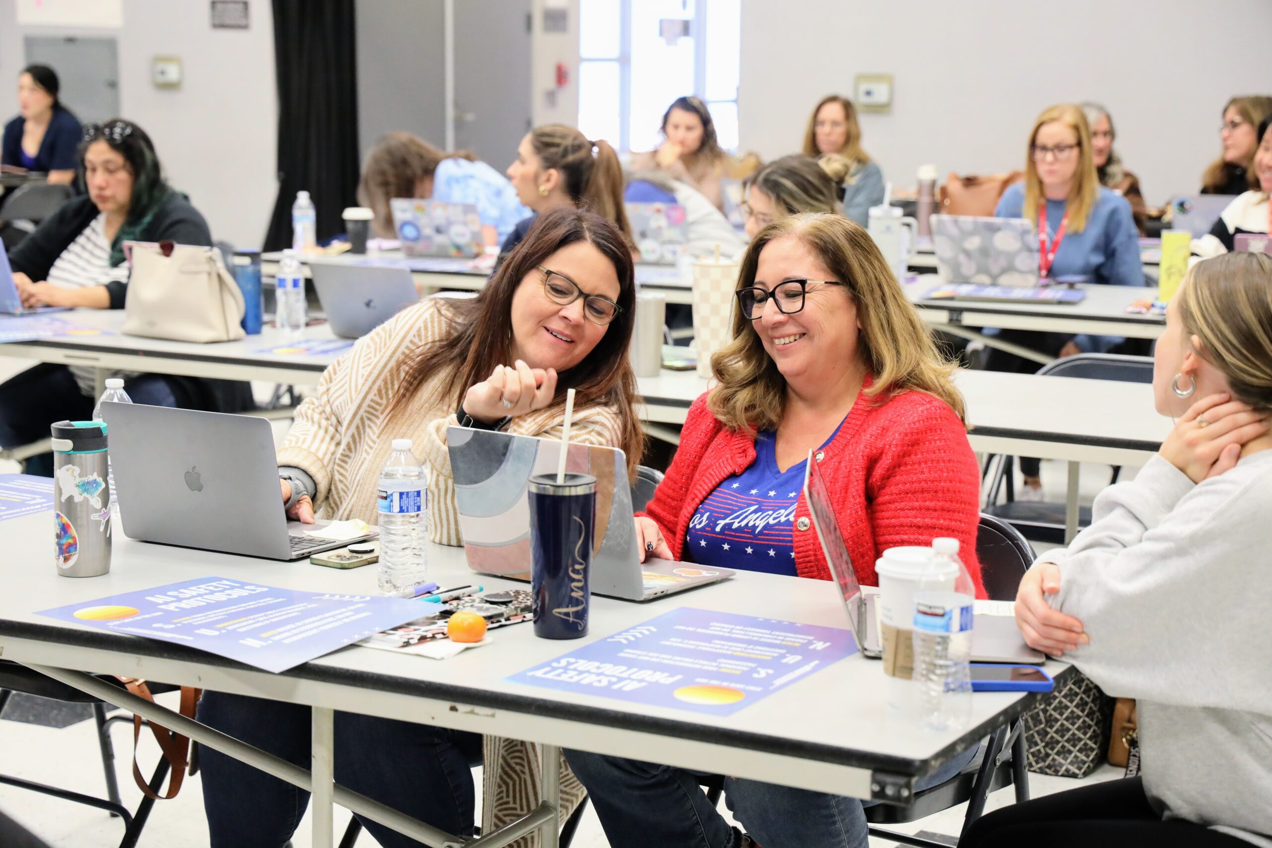 Fullerton School District educators collaborate during the 2024 Staff Development Day, where teachers used district-issued Mac devices to learn about artificial intelligence.