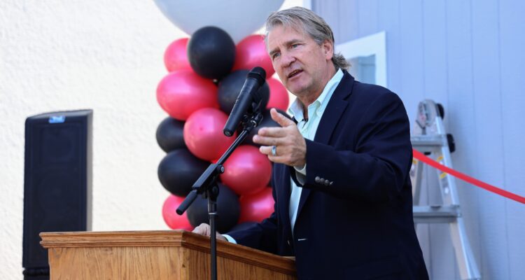 Dr. Bob Pletka, superintendent of Fullerton School District, speaking at a podium during the district’s second Tiny Home Project ribbon-cutting ceremony
