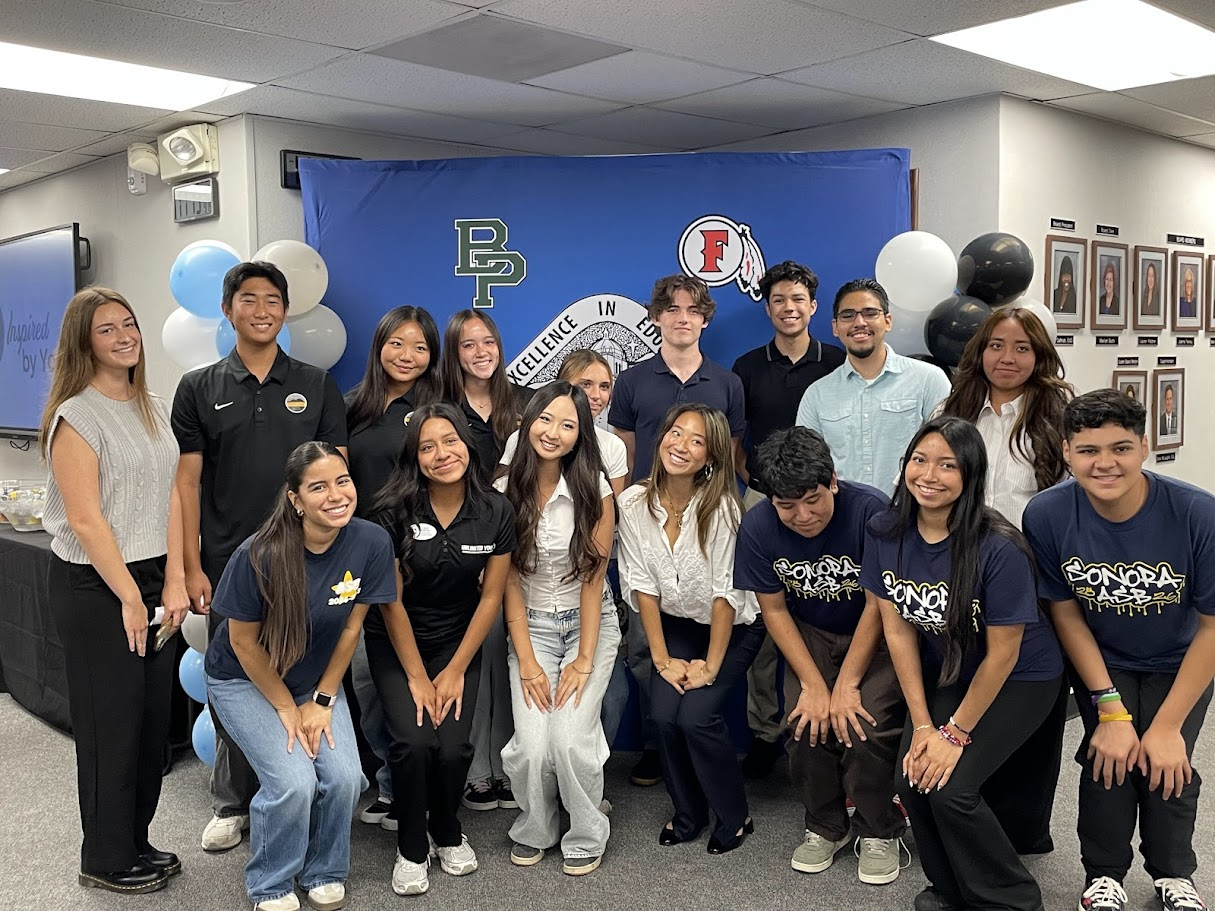 A group of student board members and student advisory committee representatives pose together at the Student Board Member Orange County Summit in Fullerton