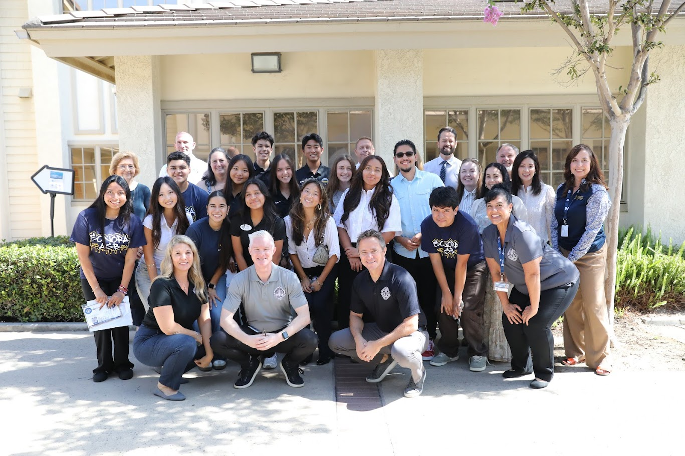 A large group of students and adults pose outside a building after the Student Board Member Orange County Summit in Fullerton. The group includes Superintendent Steve McLaughlin along with Board Members Marilyn Buchi and Joanne Fawley, standing alongside student leaders and district staff.