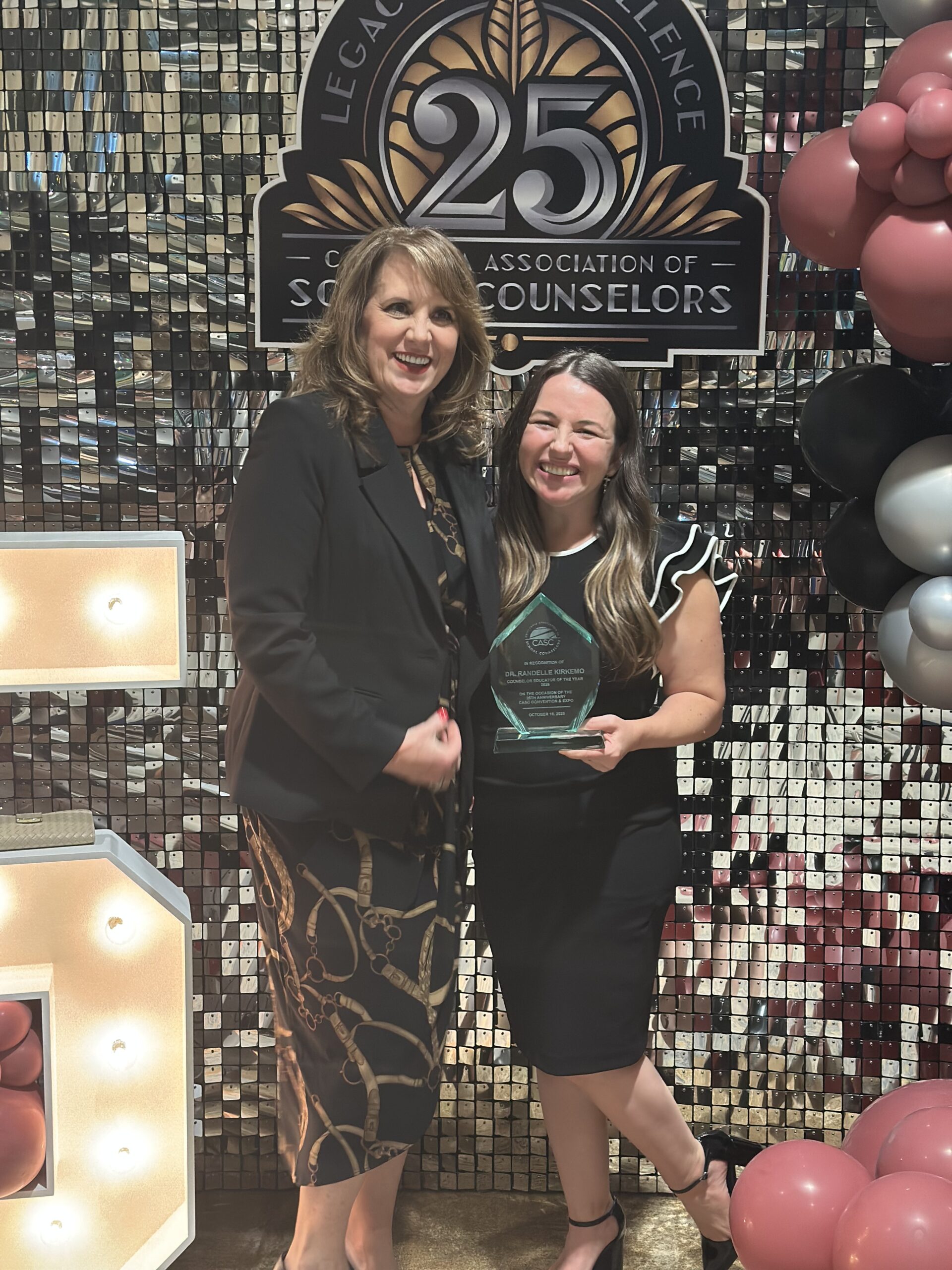 Dr. Randelle Kirkemo of Chapman University stands with Dr. Jami Parsons, the Orange County Department of Education’s executive director of Systemic Leadership and Continuous Improvement, at the California Association of School Counselors’ 25th anniversary conference in Riverside.