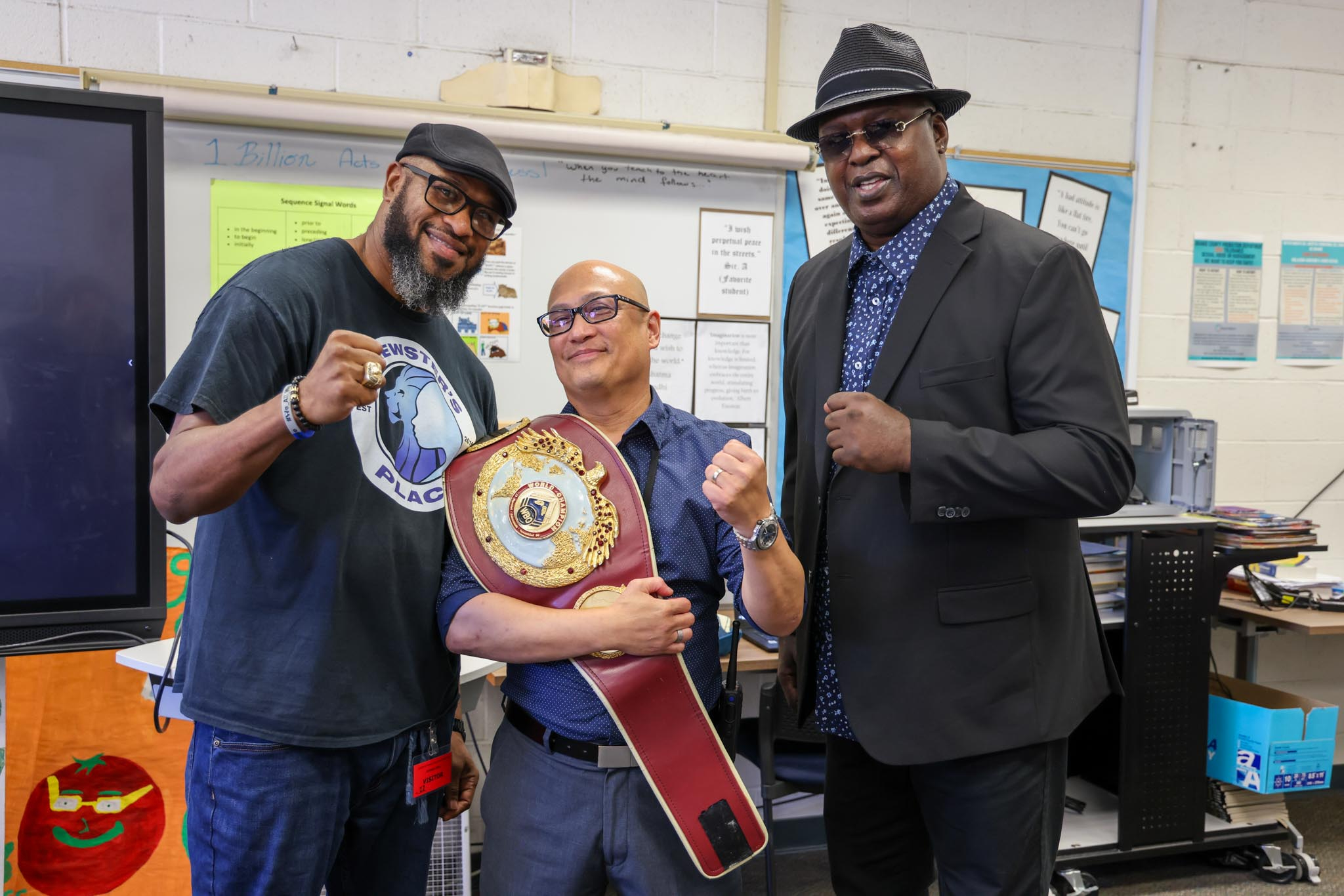 Fischer School teacher Allen Cadatal meets former heavyweight boxing champions James "Buster" Douglas and Lamon Brewster.