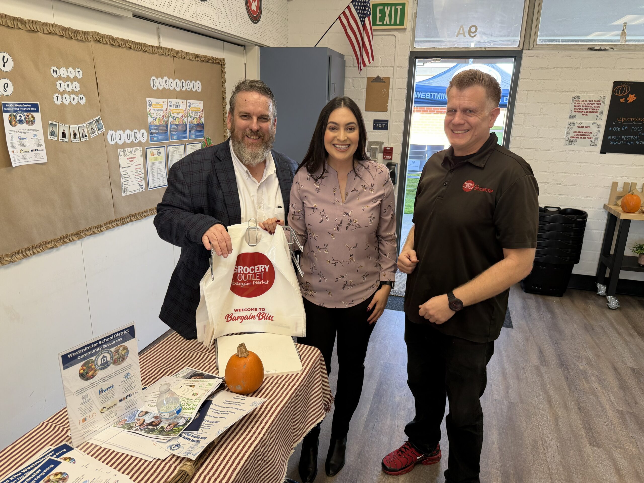 Johnson Middle School Principal Daniel Owens and WSD Family Engagement Specialist Maritza Palacio welcome guests to the new food pantry alongside local Grocery Outlet owner Tyler Mintz. (Courtesy of Westminster School District)