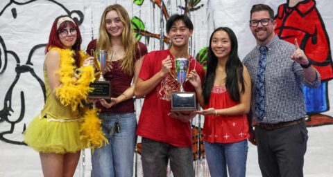 Marina High School students accept a trophy after leading the Huntington Beach Union High School District’s annual food drive.