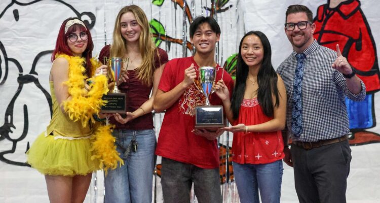 Marina High School students accept a trophy after leading the Huntington Beach Union High School District’s annual food drive.