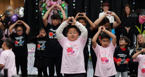 Students from Dr. Jonas E. Salk School in the Centralia School District perform during last year’s Orange County Arts and Disability Festival, raising their arms to form heart shapes with their hands.