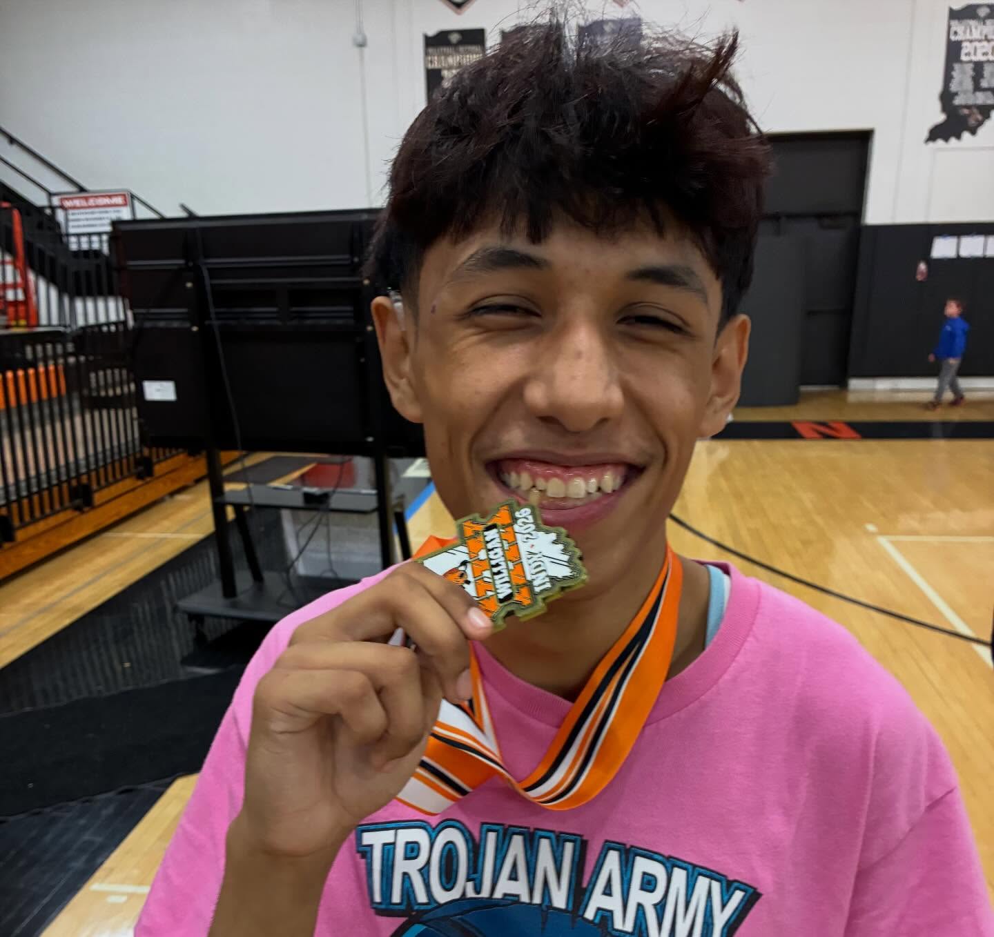 Louis Saldana shows off his medal after finishing first at 106 pounds at the Willigan Wrestling Tournament in Indianapolis.