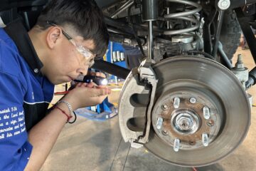 A Valley High School automotive student works beneath a vehicle during the Auto Academy Saturday Community Garage Service Clinic at the school’s CTE automotive facility.