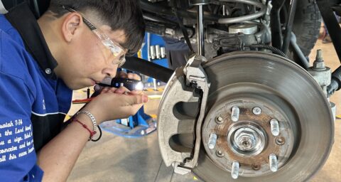 A Valley High School automotive student works beneath a vehicle during the Auto Academy Saturday Community Garage Service Clinic at the school’s CTE automotive facility.