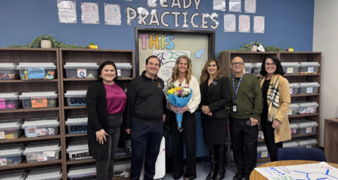 Casie Hollenbeck (center) stands with a bouquet during a CTE Month recognition visit alongside Jacquelyn Leyva, Steven Kahn, Dr. Jacqueline Cardenas, Chris Alfieri and Machele Kilgore.