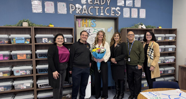 Casie Hollenbeck (center) stands with a bouquet during a CTE Month recognition visit alongside Jacquelyn Leyva, Steven Kahn, Dr. Jacqueline Cardenas, Chris Alfieri and Machele Kilgore.