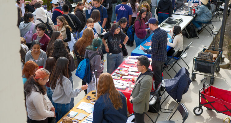 High school students from seven OC school districts connect with future employers at information booths in the Santa Ana College campus quad.